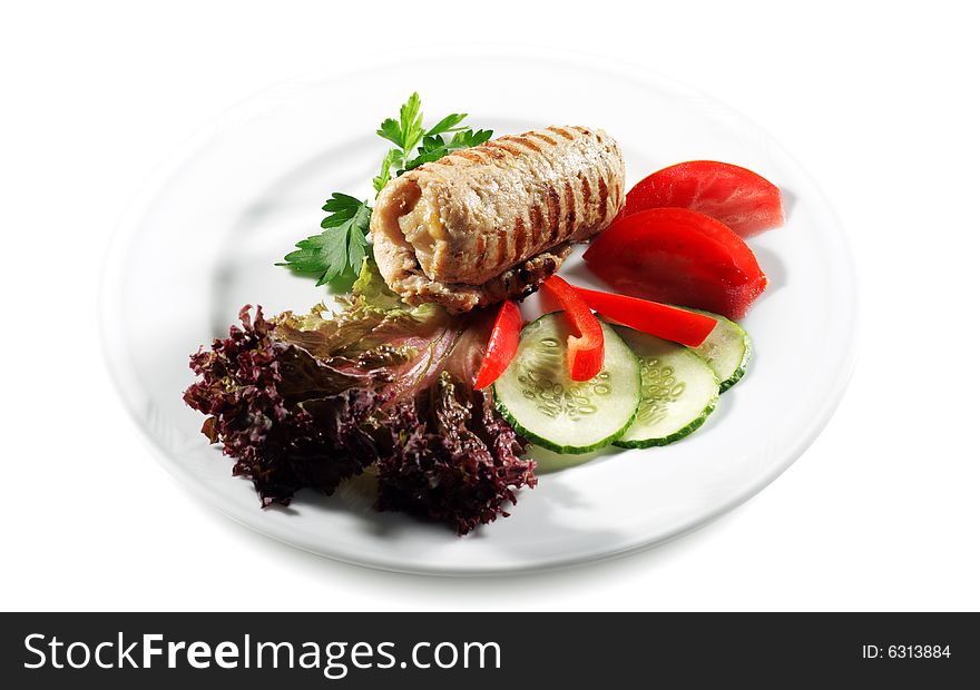 Pork (or Beef) Grilled Roll with Greens and Vegetables on a Plate. Isolated on White Background. Pork (or Beef) Grilled Roll with Greens and Vegetables on a Plate. Isolated on White Background