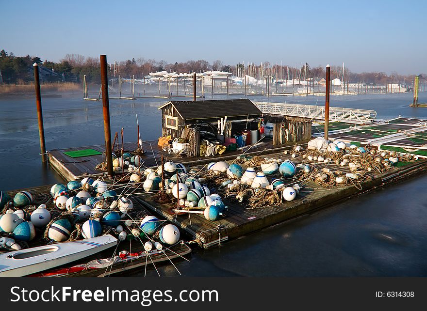 Harbor in early morning featuring dock with stored buoys. Harbor in early morning featuring dock with stored buoys.