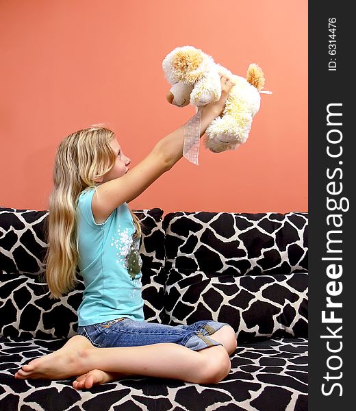 Blond young girl holds her beloved toy - plush dog. Blond young girl holds her beloved toy - plush dog.