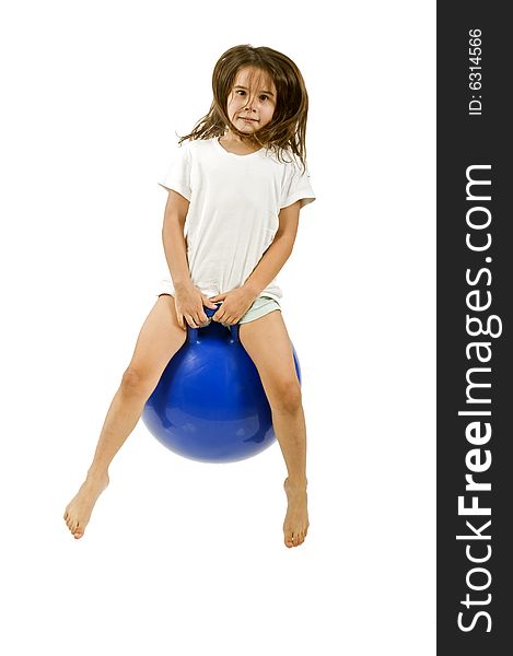 Young girl on a  blue space hopper isolated on white. Young girl on a  blue space hopper isolated on white