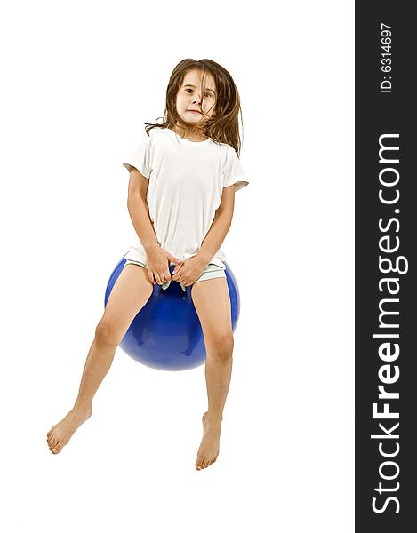 Young girl on a  blue space hopper isolated on white. Young girl on a  blue space hopper isolated on white