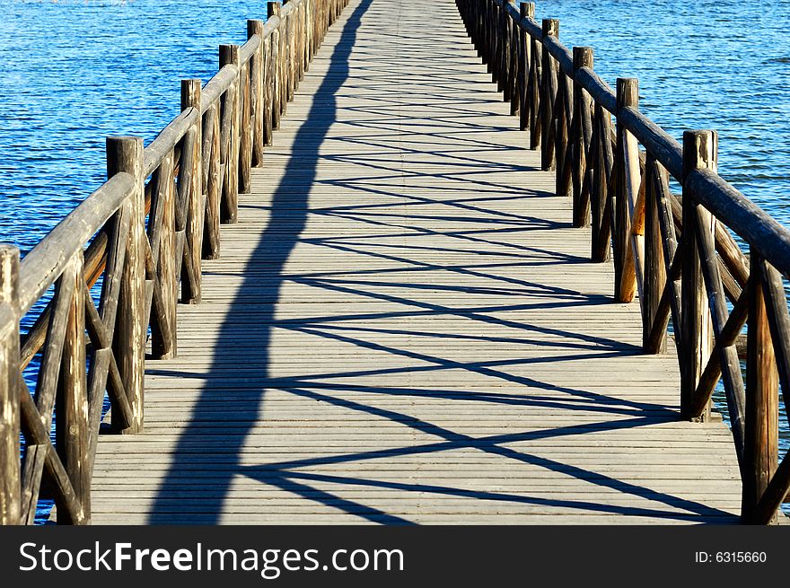 Wooden bridge stretch over the lake. Wooden bridge stretch over the lake
