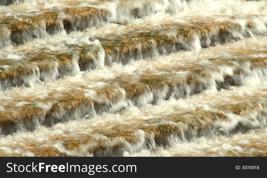 Water rushing down a flight of granite steps, creating abstract horizontal lines and blurs . Water rushing down a flight of granite steps, creating abstract horizontal lines and blurs