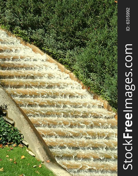 Water rushing down an outdoor flight of granite steps, surrounded by vegetation . Water rushing down an outdoor flight of granite steps, surrounded by vegetation