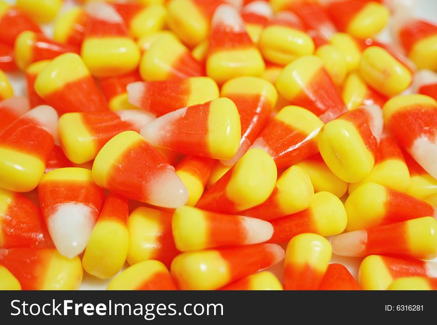 A close up of a pile of candy corn.