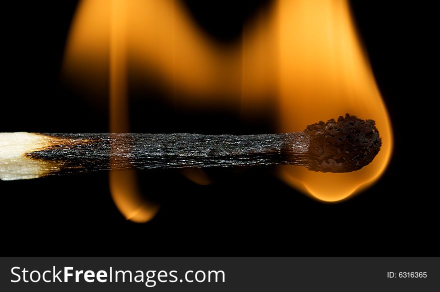 Matchstick burning with black isolated background and orange flame. Matchstick burning with black isolated background and orange flame