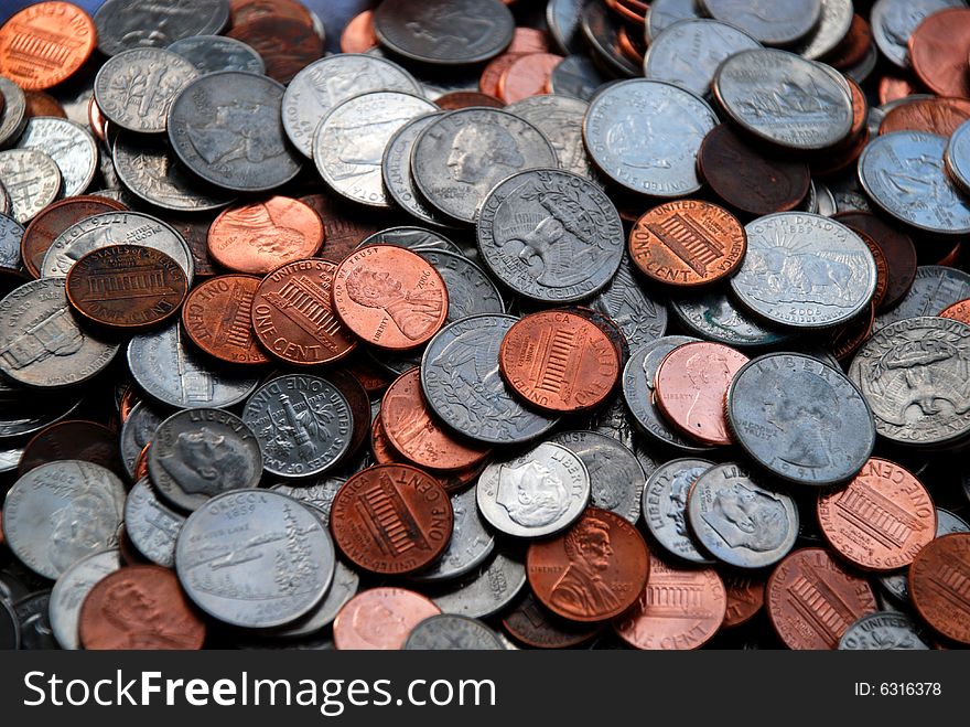 A stack of US coins - quarters, dimes, nickels and pennies. A stack of US coins - quarters, dimes, nickels and pennies.