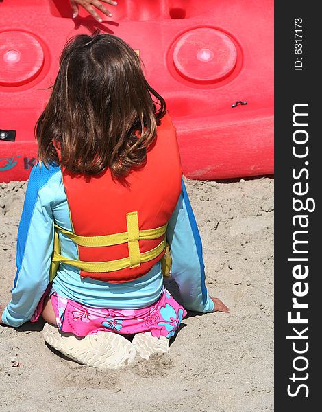 Young girl listening to safety talk wearing a life jacket. Young girl listening to safety talk wearing a life jacket.