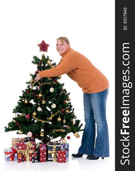 Happy girl by the Christmas tree on white background. Happy girl by the Christmas tree on white background
