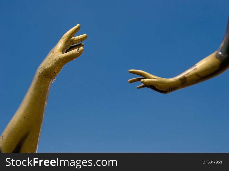 Hands reaching out to touch each other.