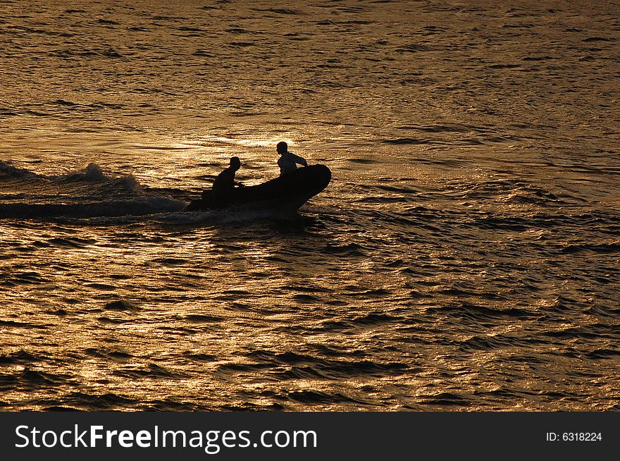 Two men in small rubber boat inside the Bosporuschannel in Istabull heeding for shore. Two men in small rubber boat inside the Bosporuschannel in Istabull heeding for shore