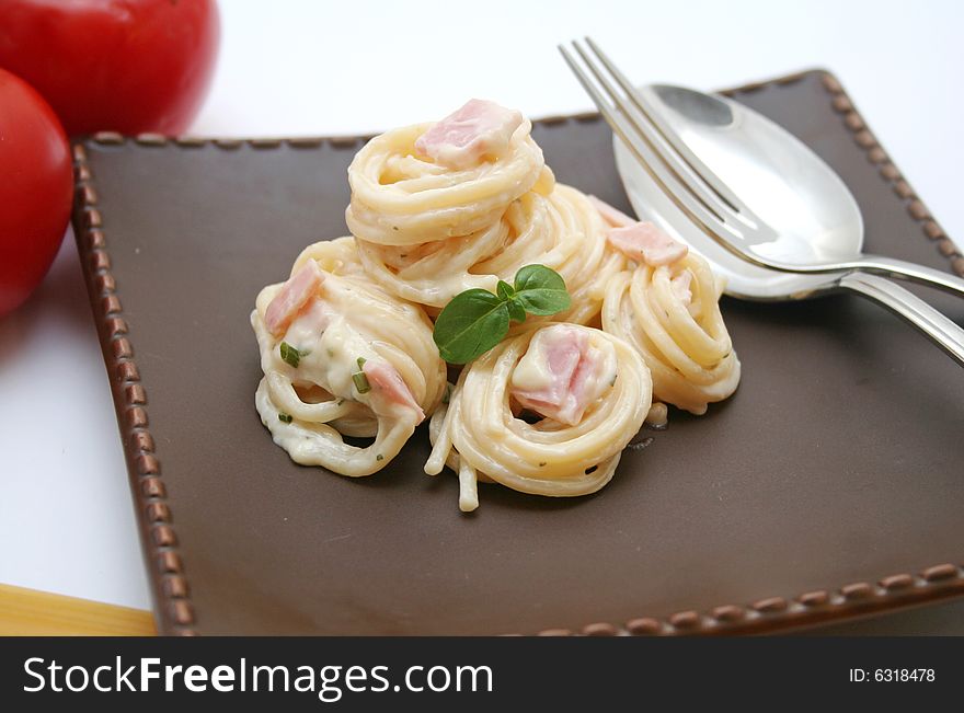 Italian spaghetti with a sauce of cheese and ham. Italian spaghetti with a sauce of cheese and ham