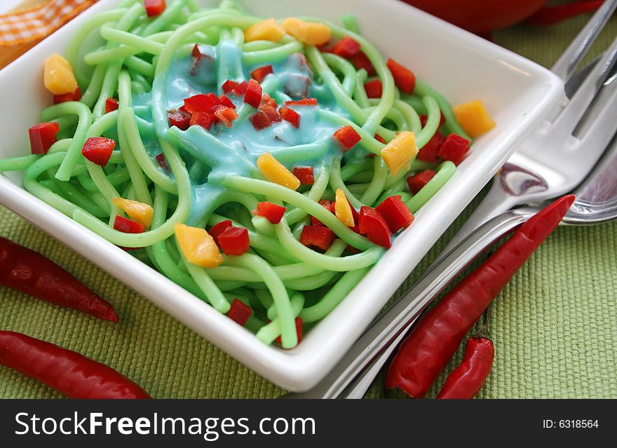 A meal of colourful pasta with cheese and pepper