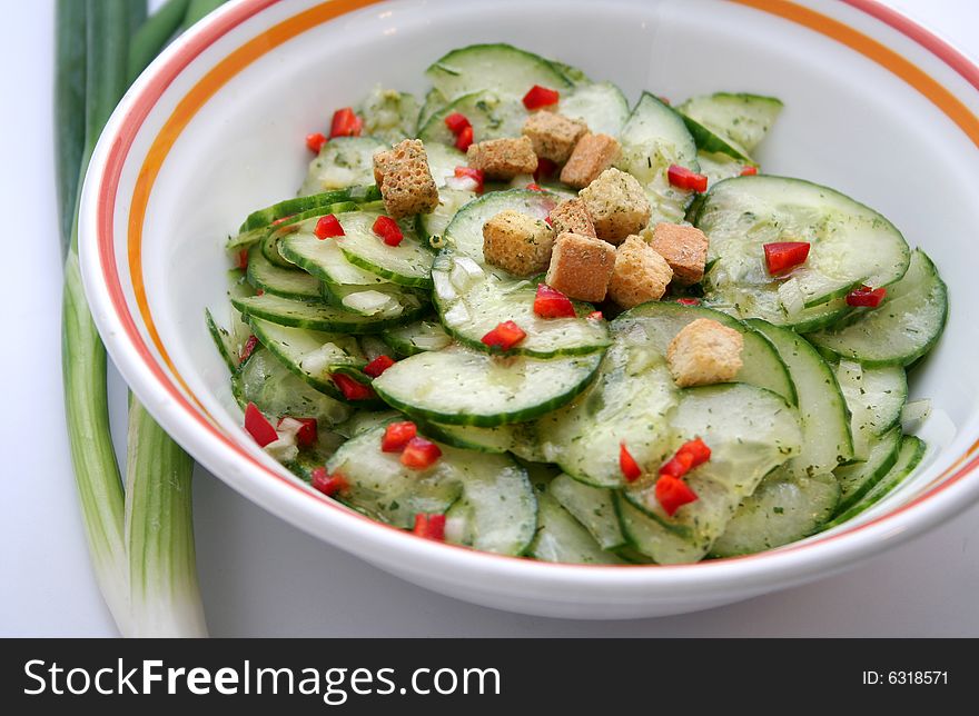 Salad of fresh cucumbers with paprika and croutons
