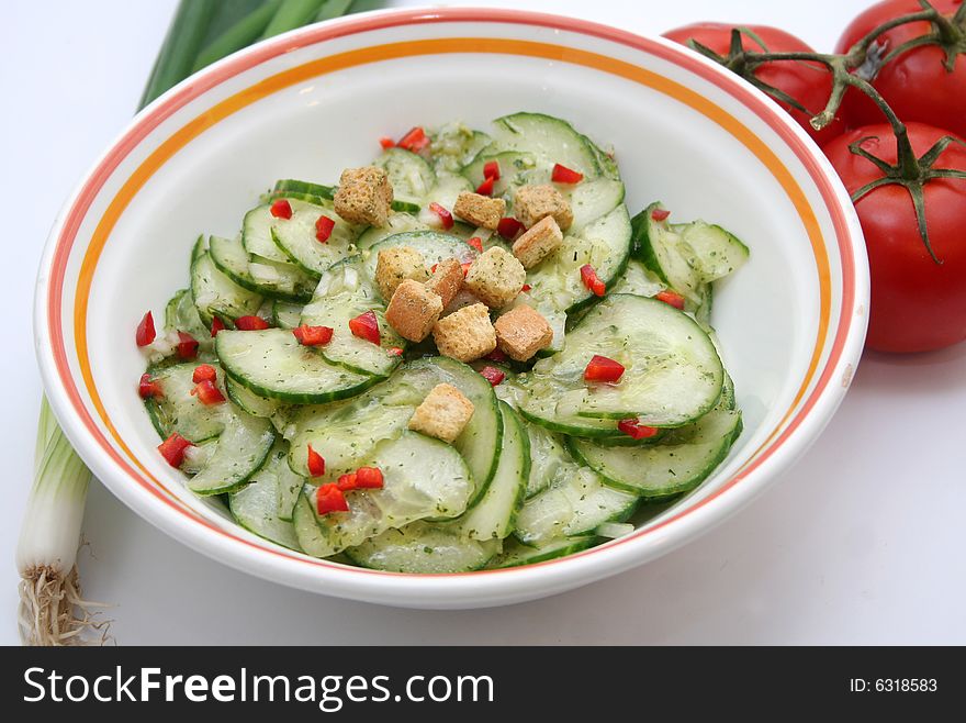 Salad of fresh cucumbers with paprika and croutons