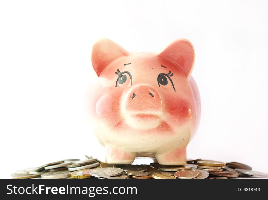 Pink piggy bank isolated on white background with coins