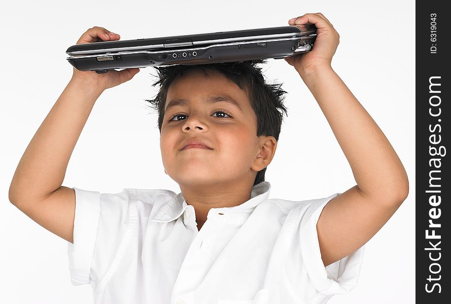 Asian boy holding laptop on his head
