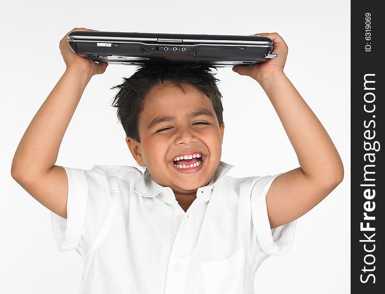 Asian boy holding laptop on his head