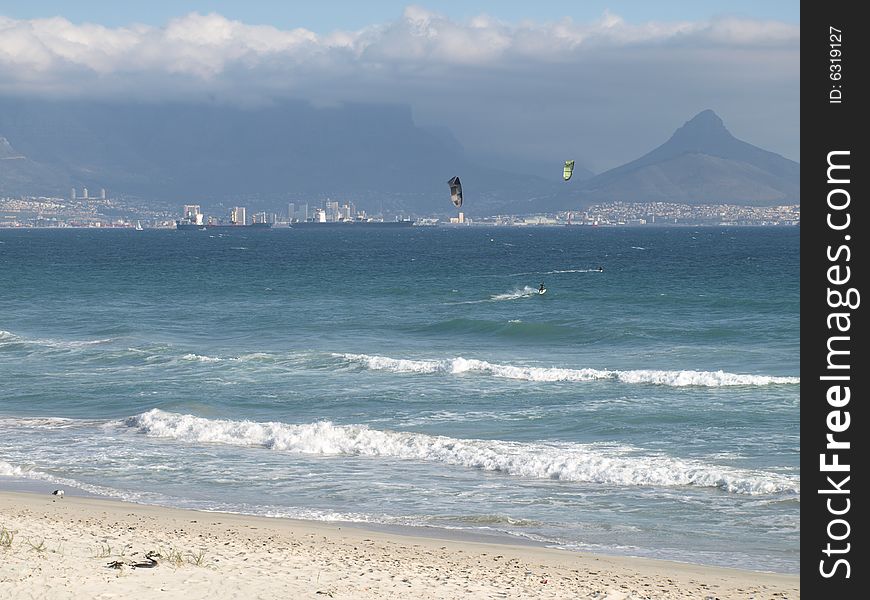 2 Kite surfers in Table Bay in South Africa with Lions Head in the background. 2 Kite surfers in Table Bay in South Africa with Lions Head in the background