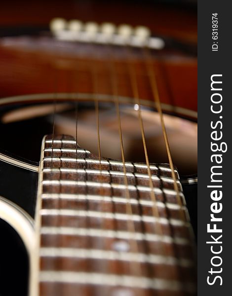 A close up of an acoustic guitar. A close up of an acoustic guitar