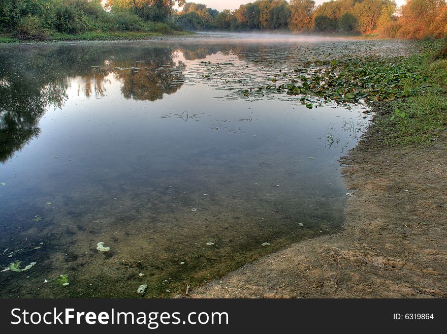 Beautiful foggy river with reflection