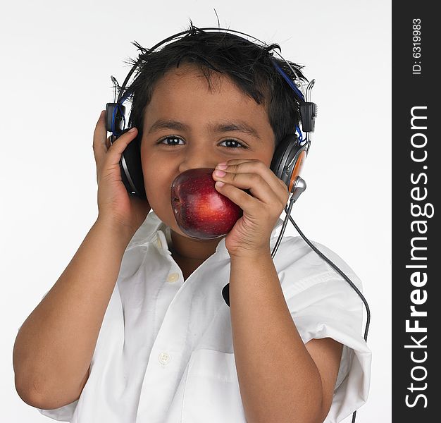 Boy biting an red apple