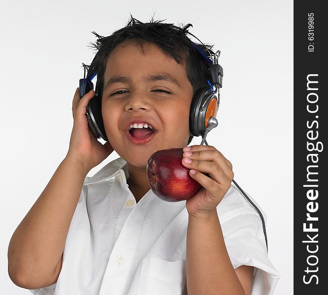 Asian boy biting an red apple