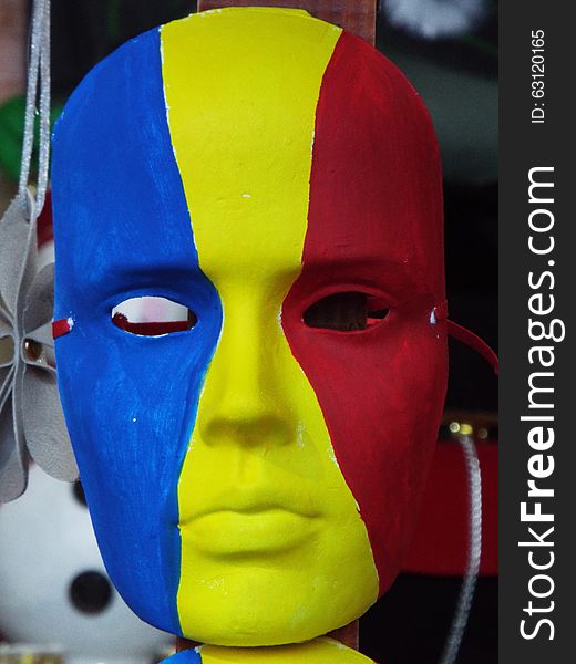 Picture with romanian mask painted in blue yellow and red. Picture with romanian mask painted in blue yellow and red