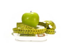 Green Apple And Tape Measure On White Stock Photos