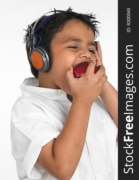 Asian boy biting a red apple