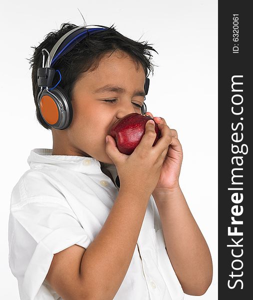 Boy biting a red apple