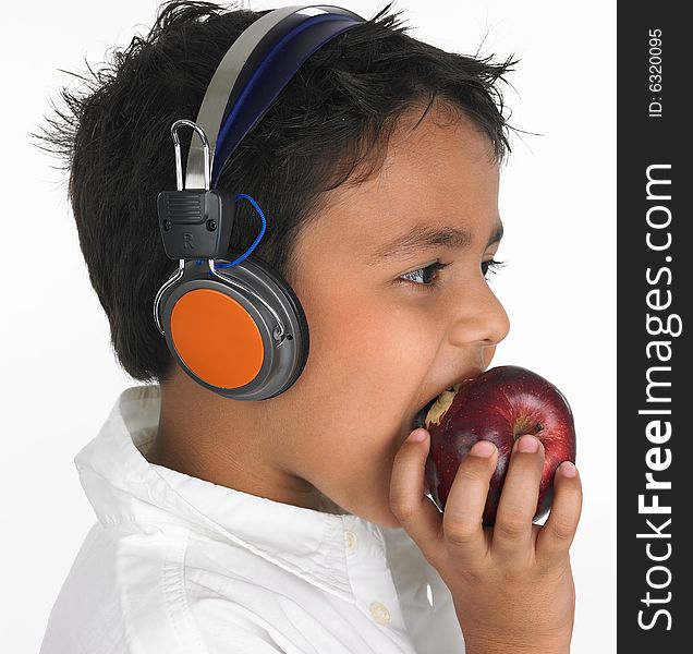 Asian boy biting a apple