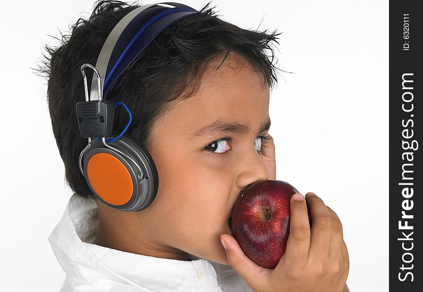 Asian boy biting a red apple