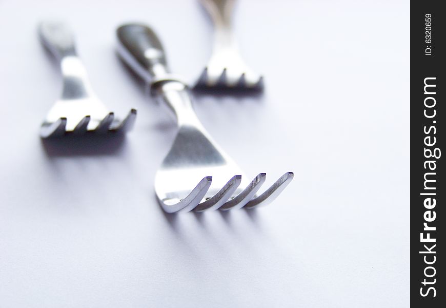 Three forks on a white