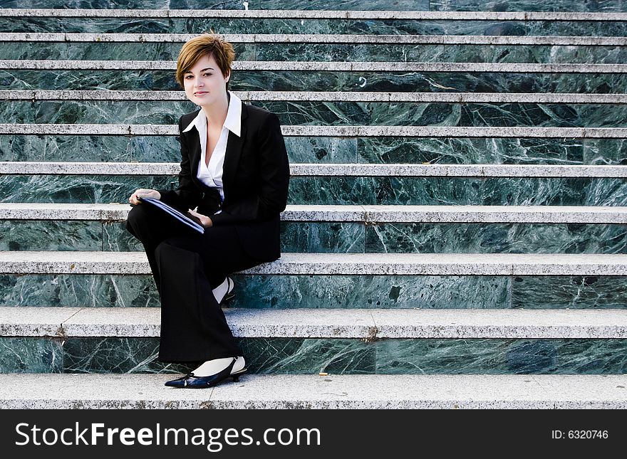 Smiling businessman over marble steps background. Smiling businessman over marble steps background.