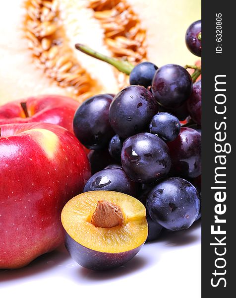 Variety of fresh colorful fruits on white background