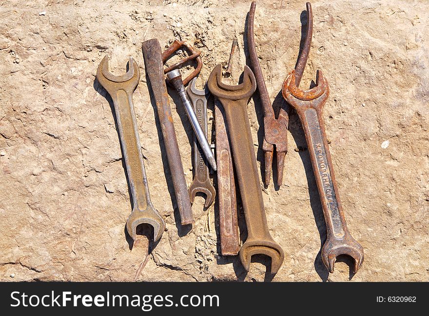 Assorted tools on concrete block. Assorted tools on concrete block.