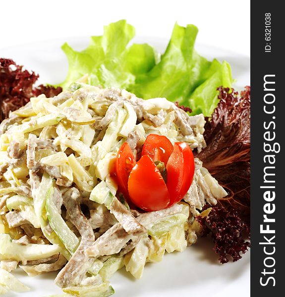 Salad from Beef and Vegetables. Serve on a Plate with Tomato and Greens. Isolated over White