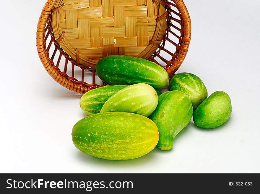 Cucumbers and wooden  basket isolated. Cucumbers and wooden  basket isolated