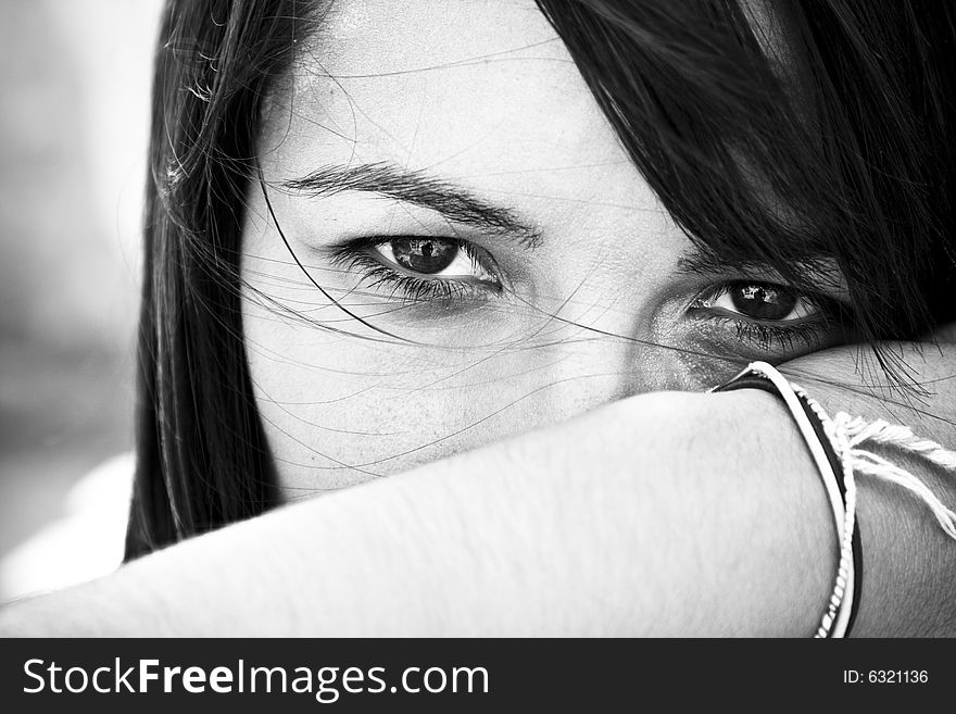 Young staring woman in contrasted black and white.