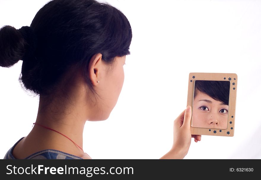 Love lady looking at mirror with wooden boarder. Love lady looking at mirror with wooden boarder