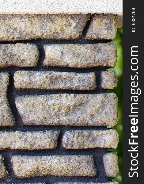 A wall of fake brick and black mortar for a background or texture. A wall of fake brick and black mortar for a background or texture