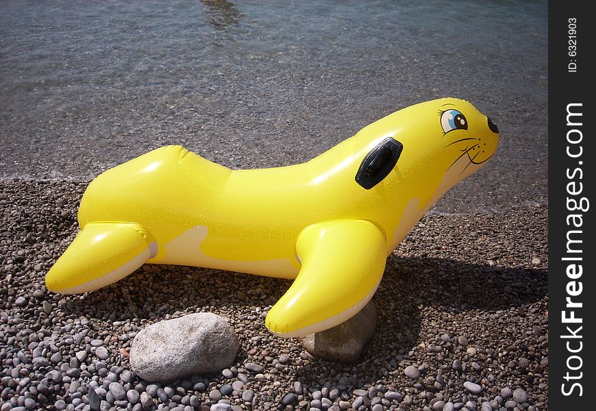 Child's inflatable swimming brightly yellow toy. Child's inflatable swimming brightly yellow toy