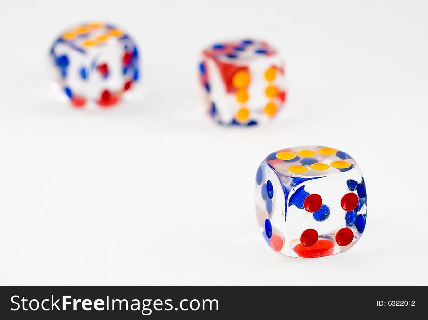 Still life of three plastic dice on white background