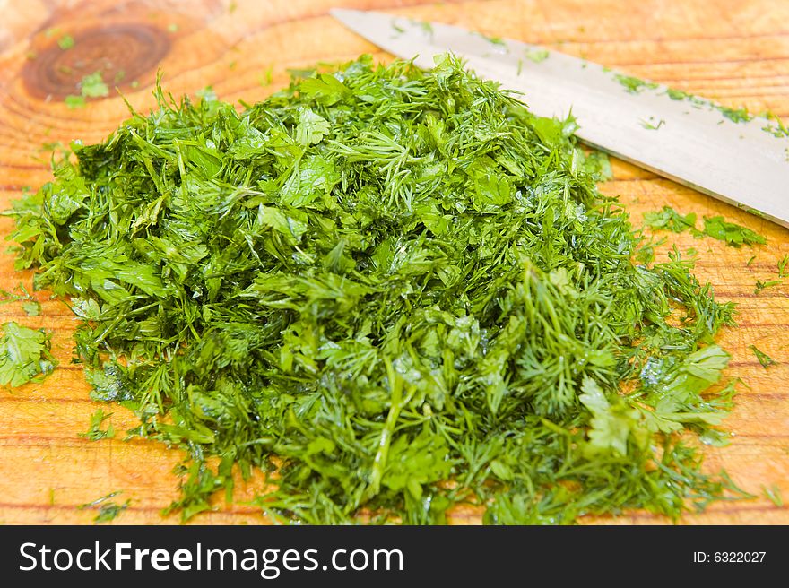 A mixture of freshly cut dill and chevril on a wooden cutting board, to be used in a gourmet meal. A mixture of freshly cut dill and chevril on a wooden cutting board, to be used in a gourmet meal.