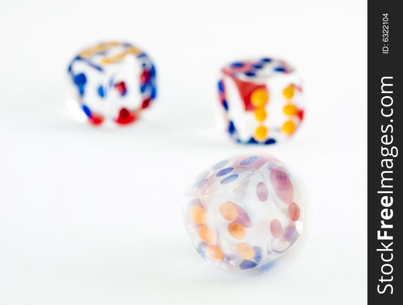 Motion blurred spinning dice against a background of two thrown dice. Motion blurred spinning dice against a background of two thrown dice