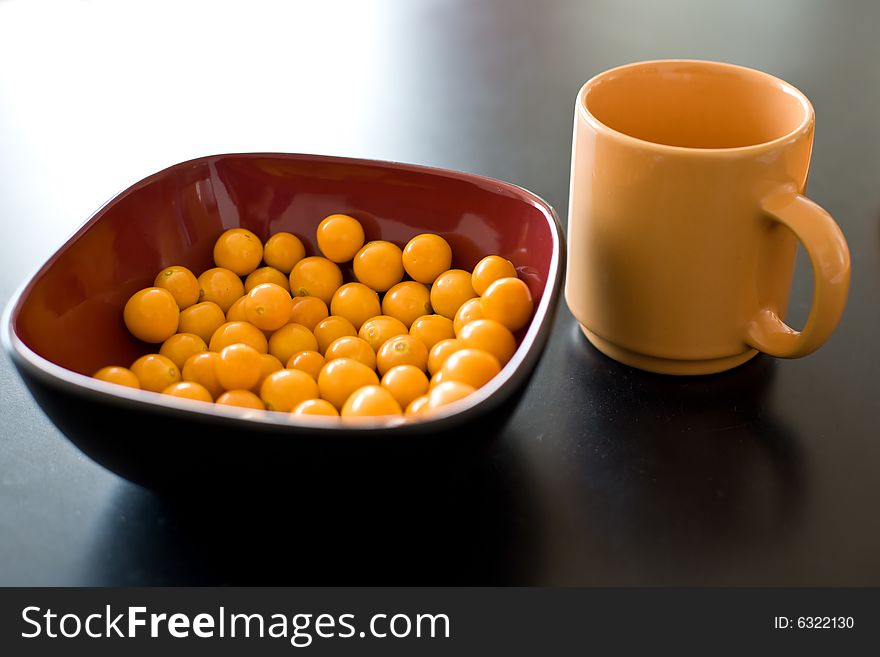 Bowl of cape gooseberry and cup