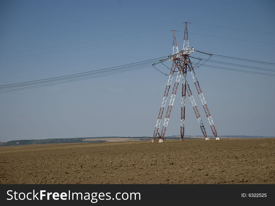 Pillars High Voltage connected electric energy power lines towers in Dobrujda plain Romania