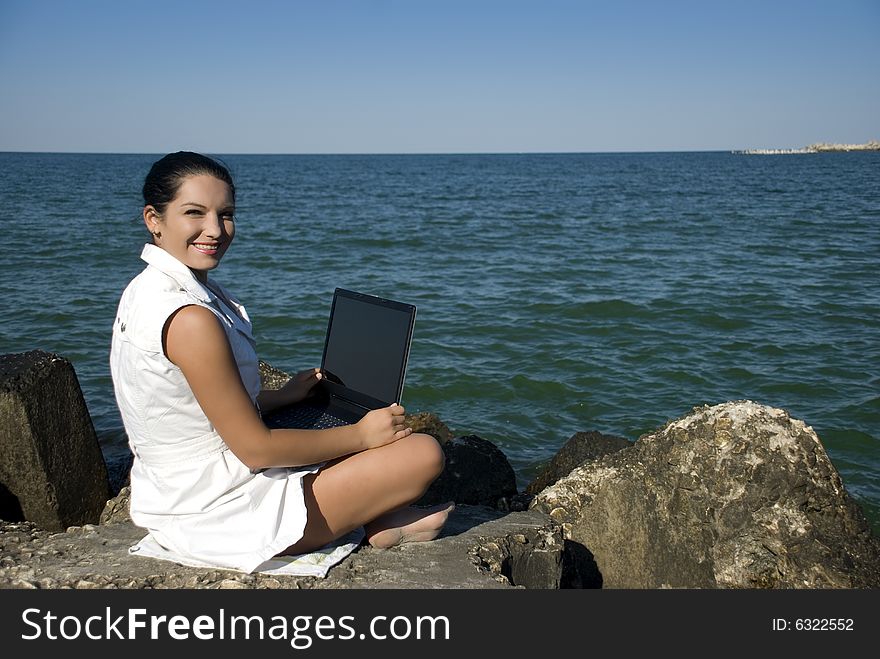 Woman With Laptop On The Beach