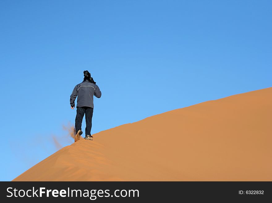 Walking on the sand dune at the desert (Morocco)